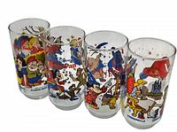 Four Disney character glass tumblers side by side showing full designs from Snow White, Peter Pan, Sorcerer Mickey, and Cinderella.