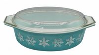 Clear image of the dish with the lid on, showing snowflake pattern and handles