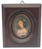 Front view of the miniature framed oval portrait print showing a woman with styled blonde hair, pearl earring, choker and pink off-shoulder dress in a wooden frame.