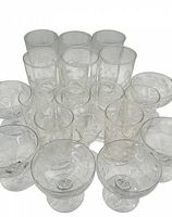Overview of all 19 glasses arranged showing various sizes and types with etched cornflower floral designs.