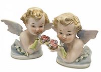 Pair of vintage bisque porcelain cherub figures painted in soft pastels holding floral bouquets, side view