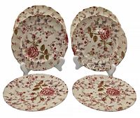 Front view of six Johnson Bros Rose Chintz sandwich plates arranged in two groups and two laid flat in front, showing the floral pattern.