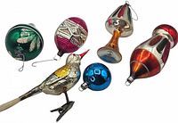 Six vintage glass Christmas tree ornaments including a bird and various shaped bulbs in colors green, pink, blue, amber, and silver with glitter and paint decoration.