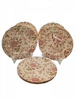 Six vintage Johnson Bros Rose Chintz dinner plates shown on stands and stacked, displaying floral pattern and scalloped edges