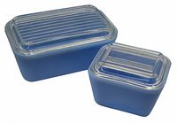 Two delphite blue Pyrex refrigerator dishes with clear glass lids, shown side by side from top to display lids