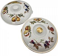 Top view of both tureen lids showing fruit and vegetable designs with gold accents