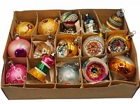 Top-down view of all fifteen ornaments in original cardboard divider box