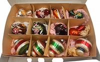 Box of 12 partitioned compartments each holding an ornament