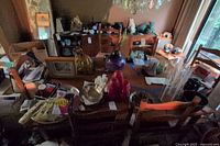 Overhead view of the wood dining table surface with decorative items and four chairs around.
