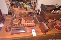 Overview of various wooden bowls, trays, and kitchen accessories arranged on a wooden surface