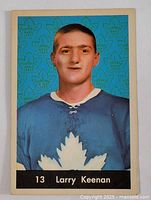 Front side of the 1961-62 Parkhurst Larry Keenan hockey card showing player portrait in Toronto Maple Leafs jersey with blue patterned background.