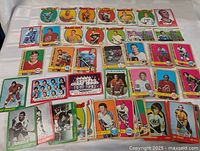 Overhead photo displaying a spread of multiple hockey cards laid out showing player portraits and team logos of early 1970s OPC cards.