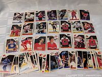Array of 33 hockey cards from the 1985-86 O-Pee-Chee set, showing fronts with players and team logos.