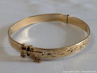 Full front view of the hinged bangle bracelet laid flat