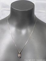 Front view of the sterling silver necklace with amethyst pendant displayed on a mannequin bust.