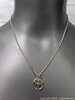 Front view of sterling silver 18-inch chain with Tree of Life pendant on black mannequin bust.