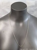 Front view of 24-inch sterling silver rope chain necklace displayed on a black mannequin bust.