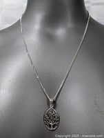 Front view of the necklace displayed on a mannequin showing the pendant and chain length.