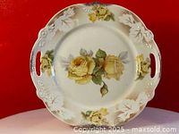 Full view of the antique Bavaria cake plate showing hand painted yellow roses on cream colored porcelain with embossed rim and cutout handles.