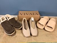 Three pairs of size 10 shoes including brown L.L. Bean fleece bootie, nude VIVAIA slip-on shoes in box, and nude rubber bath slippers.