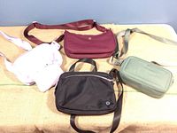 All four nylon crossbody bags displayed on table