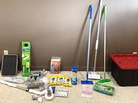 Full view of the cleaning lot items arranged on carpet showing mops, step stool, storage tub, and cleaning supplies