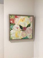 Full view of the colorful summer flower bouquet painting hanging on the wall showing overall composition and frame.