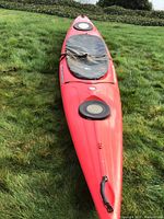 Red Wilderness Systems Pungo 140 kayak on grass showing deck and hatches