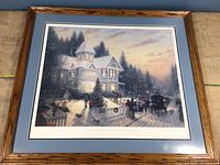 Full view of the framed print showing a Victorian Christmas scene with detailed house, Christmas tree, and people in period clothing at dusk.