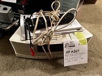 Bose Wave Radio/CD/Alarm main unit with original remote, AC power cord, and handwritten lot note