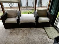 Two rattan chairs and ottoman arranged side by side