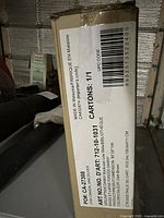 Box showing shipping label and product info for Danny low/wide bookcase from JYSK, including model and size details.