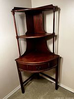 Full view front angle of the three-tier corner shelf unit