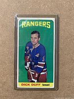 Front of the 1964-65 OPC Dick Duff hockey card showing player in Rangers blue jersey, with 'RANGERS' text and player's name and position at the bottom.