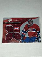 Front of the 2007-08 Upper Deck Sweet Shot Sweet Stitches Patrick Roy hockey jersey card showing four embedded red jersey patches and serial number 149/299.