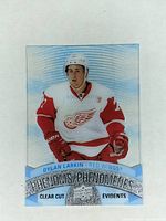 Front side of the 2017-18 Upper Deck Tim Hortons Dylan Larkin Clear Cut Phenom CCP-2 hockey card showing the player in Detroit Red Wings uniform with blue and holographic wave background.
