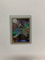 Front of the 2017 Topps Silver Pack Chrome baseball card featuring Hank Aaron in a batting stance, designed with a 1987 Topps holographic background.