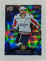 Front of hockey trading card showing Alex Ovechkin in Capitals jersey with holographic background.