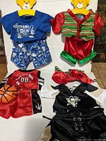 Blue guitar-themed shirt and shorts, red and green elf dress, red basketball jersey and shorts, black hockey outfit