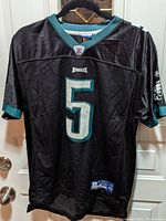 Black Donovan McNabb #5 Eagles jersey on hanger, front view showing logos and number