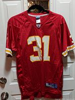 Front view of red Kansas City Chiefs football jersey with number 31 and NFL logo on collar area.