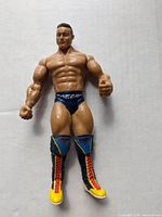 Front view of Rene Dupree action figure showing detailed torso, arms, and colorful boots.