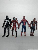 Front view of four Spider-Man related action figures showing Spider-Man, Venom, Carnage, and a Spider-Man variant figure.