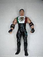Front view of the Super Crazy wrestling action figure showing detailed Mexican flag on torso and muscular arms.
