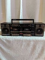 Front view of the vintage Sony boombox showing dual cassette decks, speakers, and control buttons.