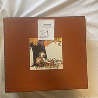 Front of brown slipcase with Calvin and Hobbes image showing minor creasing on top right corner.