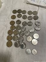Overview of 36 Canadian nickel 5-cent coins laid out in rows with varying wear, mostly dated 1967.