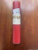 Red cylindrical tube labeled with decorative traditional Chinese style rabbits and floral images, stating 'Year of the Rabbit 2011'.