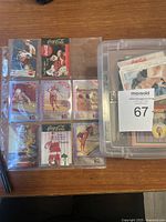 Trading cards in clear sleeves showing various Coca Cola themed cards including Santa Claus, sports, and holiday scenes.