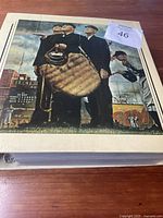 Front cover of large binder with vintage baseball art showing three men in old-fashioned baseball uniforms and a pitcher in mid-pitch.